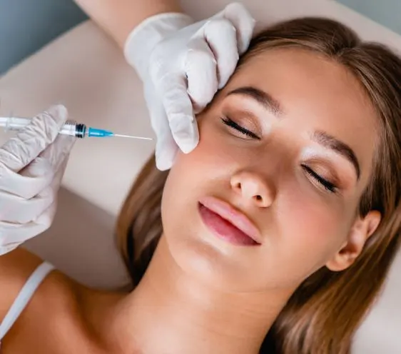 A woman receiving an injection to the forehead