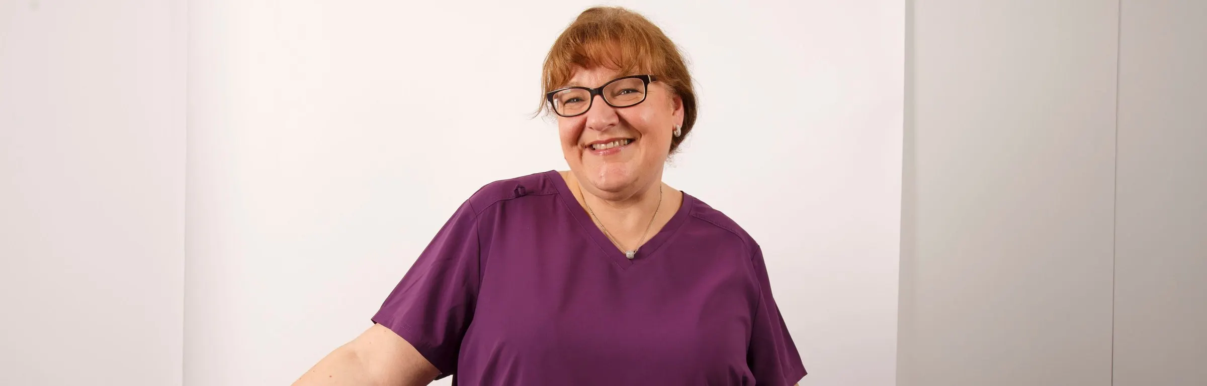 Dr Anne-Marie Smith, consultant orthodontist, in purple scrubs