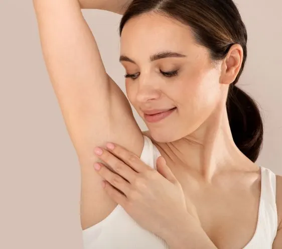 A woman with her arm raised, showing the underarm area