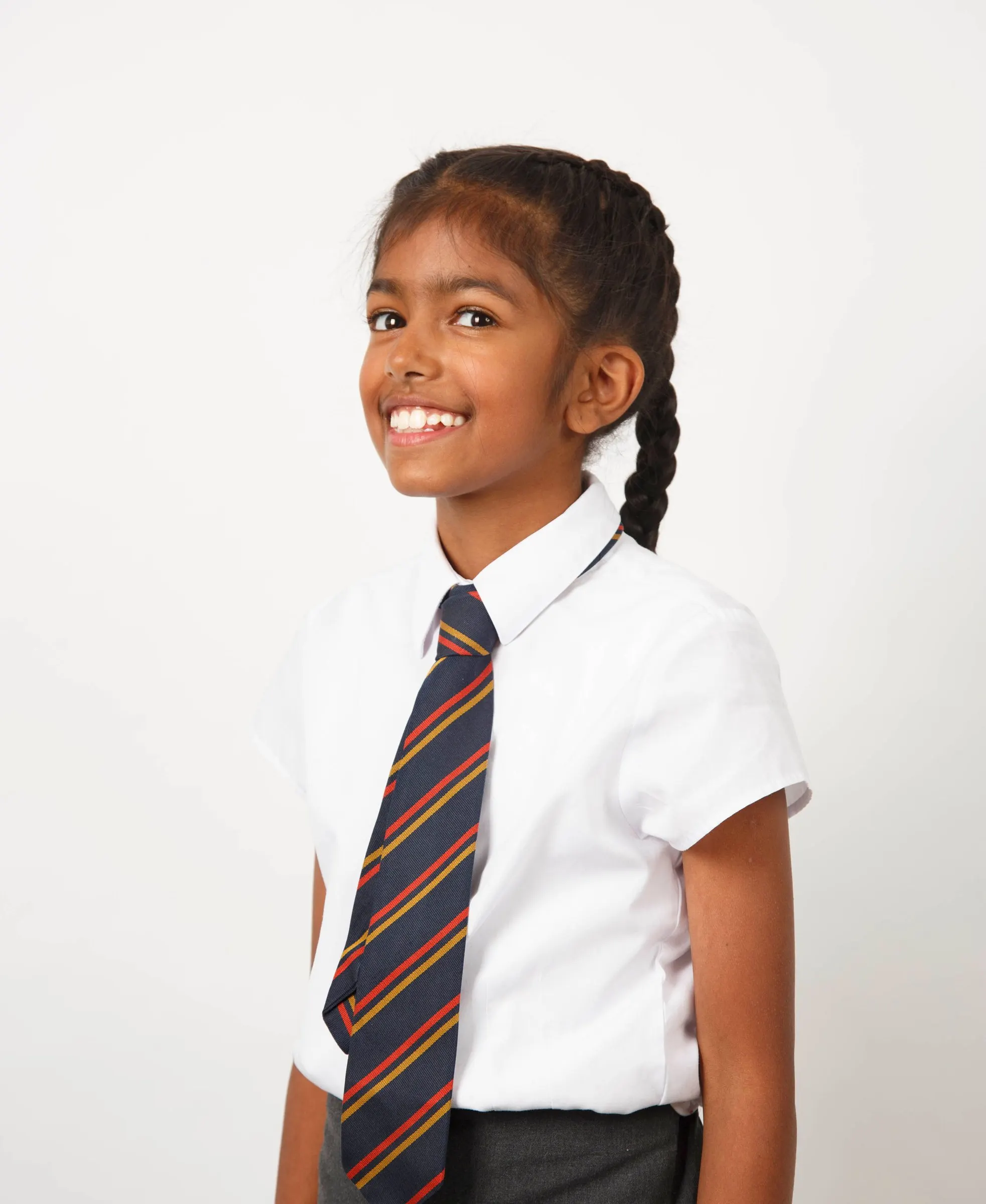 A girl in school uniform smiling