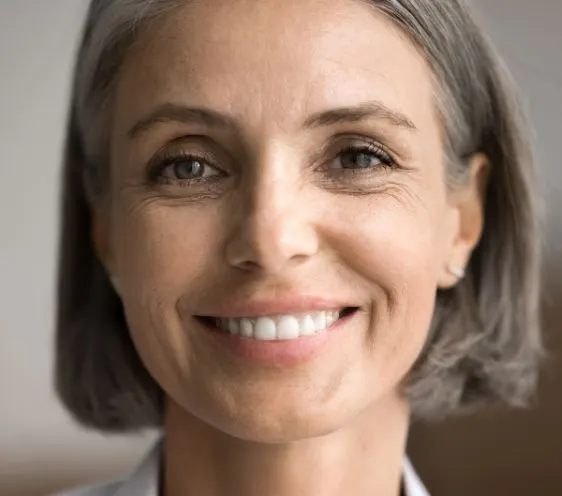 A woman with grey hair smiling