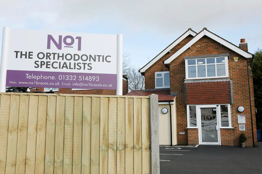 The No1 The Orthodontic Specialists signboard outside the practice on Station Road, Mickleover